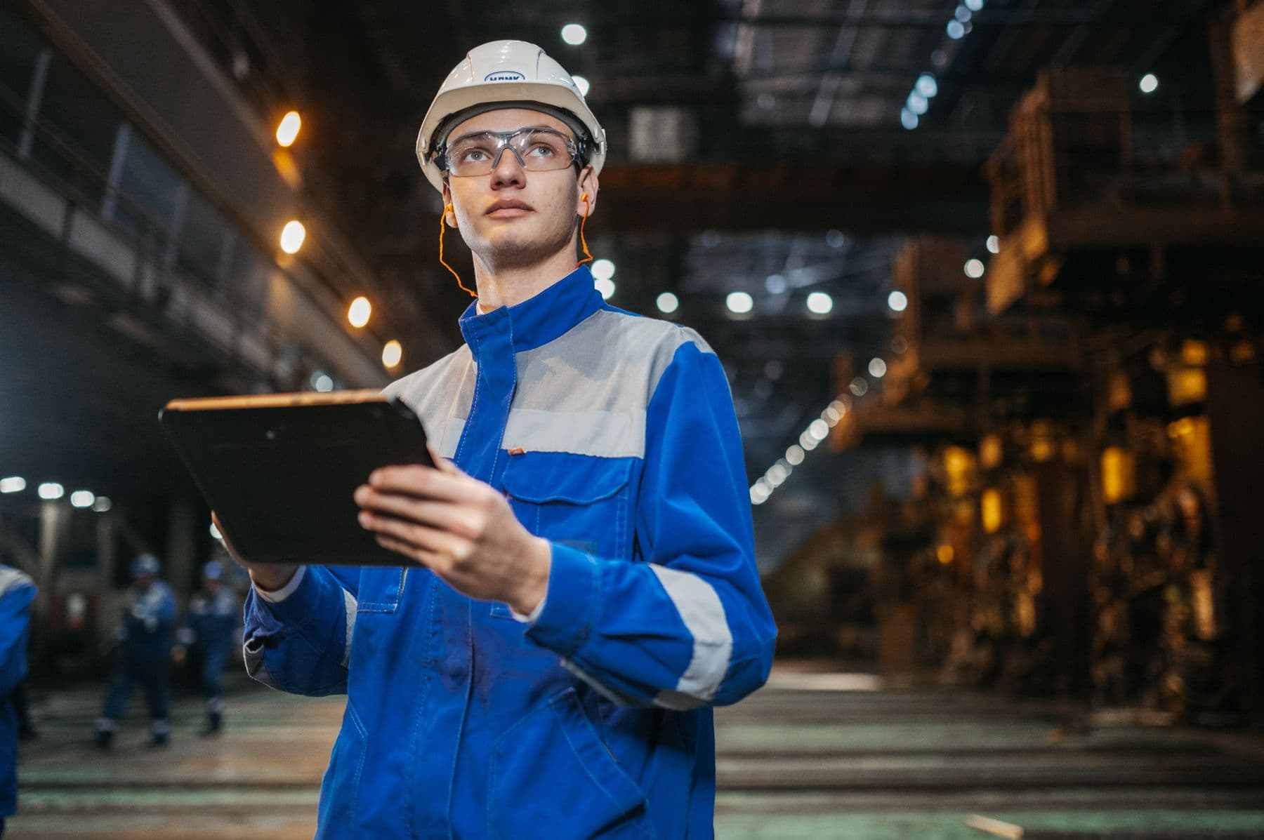 Engineer reviewing information in an industrial facility
